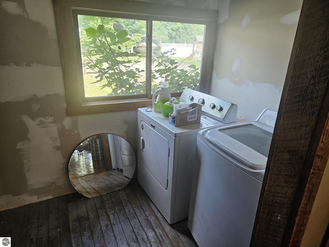 washroom featuring hardwood / wood-style floors and washing machine and clothes dryer