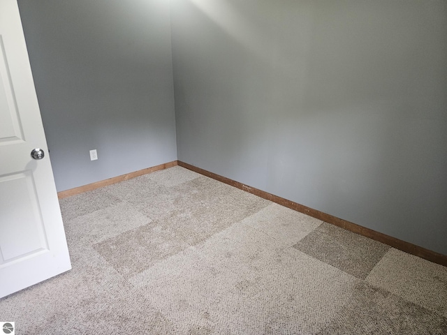 empty room featuring light colored carpet