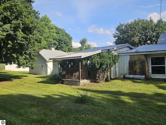 rear view of property featuring a lawn