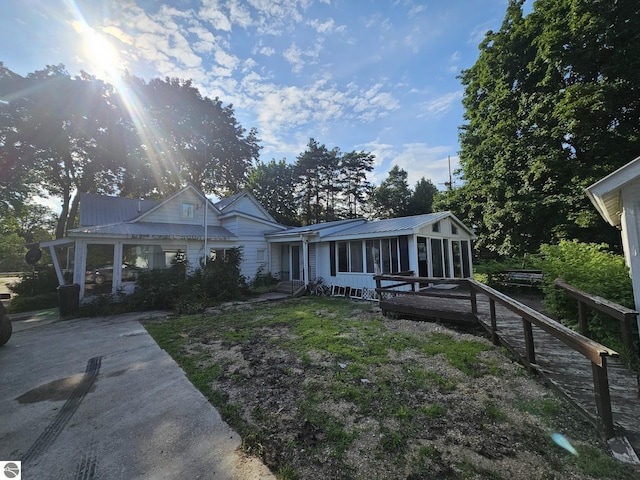 view of front of home featuring a sunroom