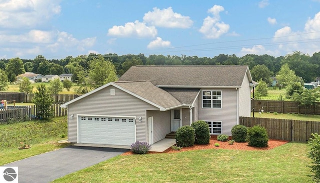 view of front of house with a garage and a front yard