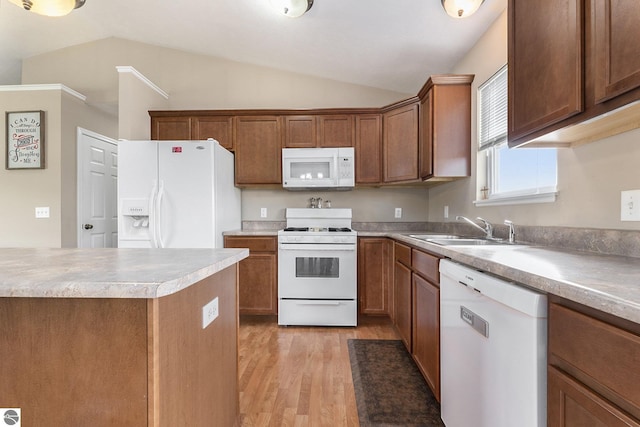 kitchen featuring white appliances, lofted ceiling, sink, and light hardwood / wood-style flooring