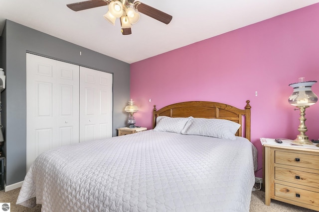 carpeted bedroom featuring a closet and ceiling fan