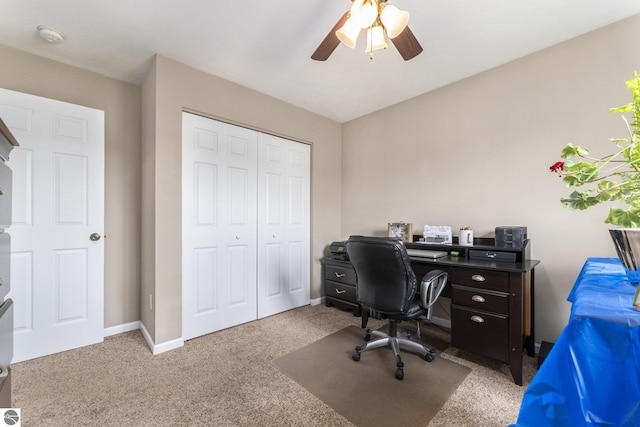 carpeted office space with ceiling fan