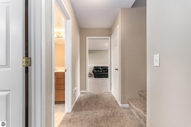 hall featuring light colored carpet