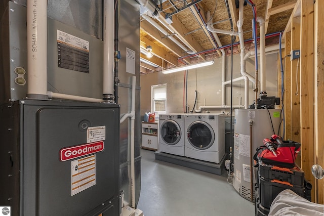 interior space featuring gas water heater, heating unit, and washer and clothes dryer