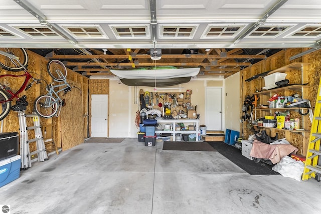 garage featuring a garage door opener and a workshop area