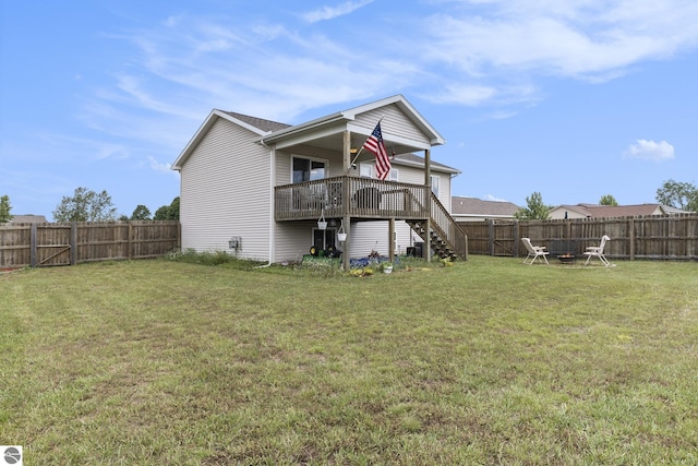 back of property featuring a wooden deck and a lawn