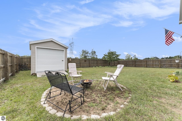 view of yard with a storage shed and an outdoor fire pit