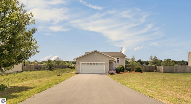 ranch-style home with a garage and a front lawn