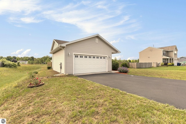 view of property exterior featuring a garage and a lawn