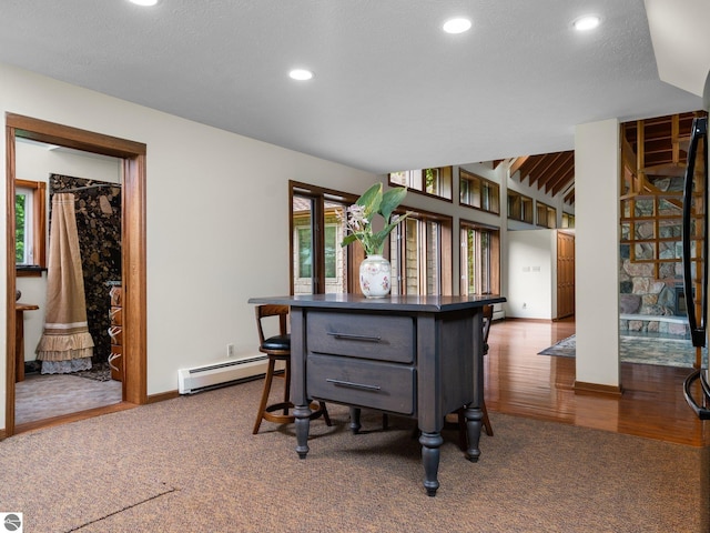 dining room with carpet flooring, a textured ceiling, and a baseboard heating unit