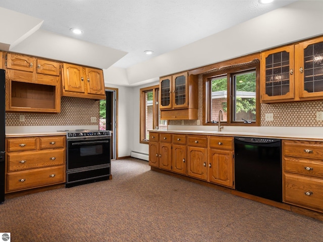 kitchen with black appliances, backsplash, a wealth of natural light, and a baseboard heating unit