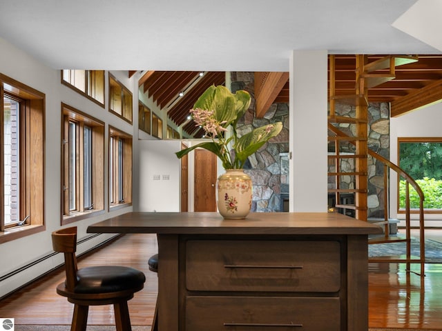 bar with hardwood / wood-style floors and dark brown cabinetry