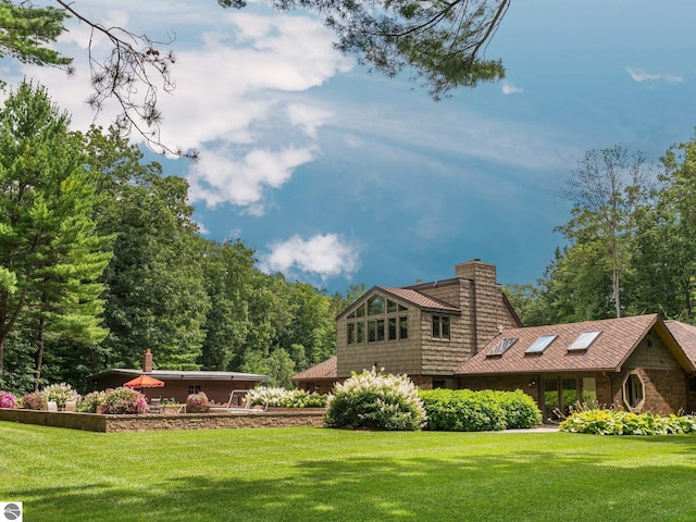 rear view of house with a lawn