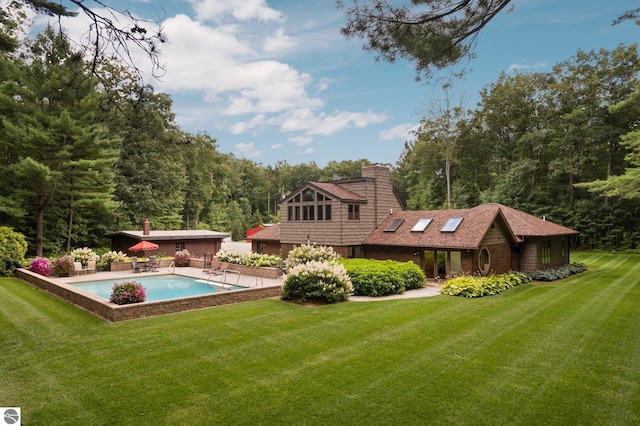 back of property with a patio and a lawn