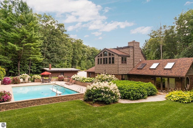 view of swimming pool featuring a lawn and a patio