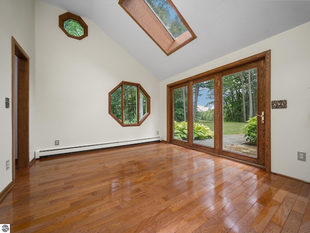 empty room featuring high vaulted ceiling, light hardwood / wood-style floors, a baseboard radiator, and a skylight