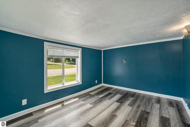 unfurnished room featuring dark wood-type flooring and a textured ceiling