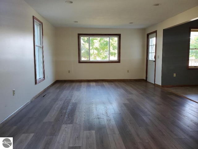 empty room with dark hardwood / wood-style flooring