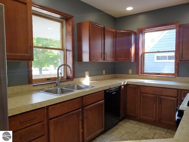 kitchen featuring electric stove, sink, light tile patterned floors, and dishwasher