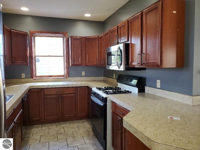 kitchen featuring black appliances and plenty of natural light