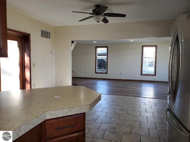 kitchen featuring dark wood-type flooring, stainless steel fridge, and ceiling fan