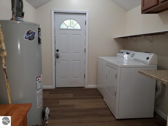 laundry area featuring dark wood-type flooring, cabinets, water heater, and washer and clothes dryer