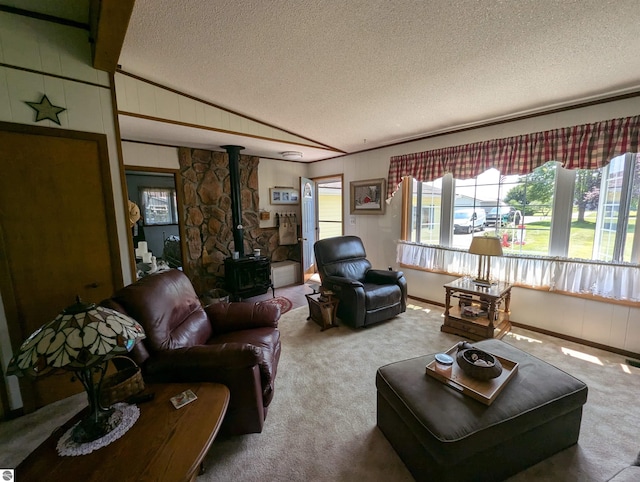 living room featuring carpet floors, a textured ceiling, and a wood stove