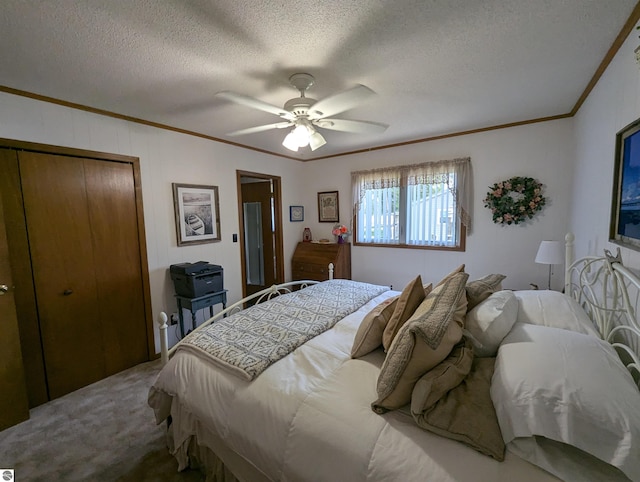 carpeted bedroom featuring a closet, a textured ceiling, and ceiling fan