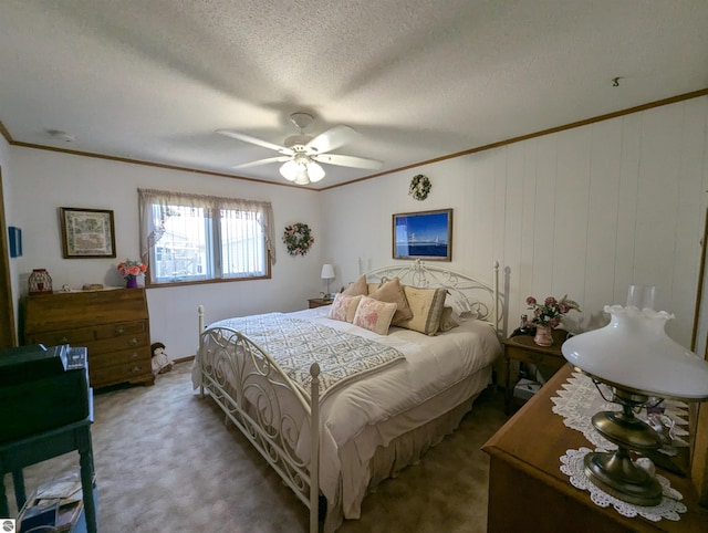 bedroom featuring a textured ceiling, ceiling fan, and carpet flooring