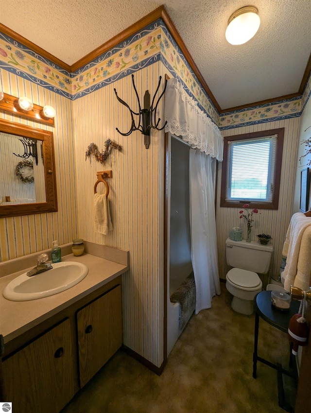 bathroom with toilet, vanity, and a textured ceiling