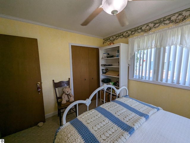 carpeted bedroom with crown molding, a closet, and ceiling fan