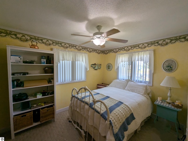 carpeted bedroom featuring a textured ceiling and ceiling fan