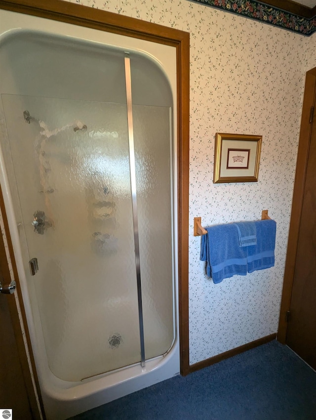 bathroom featuring a shower with door