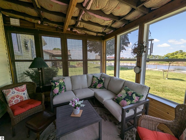 sunroom featuring a water view and a wealth of natural light