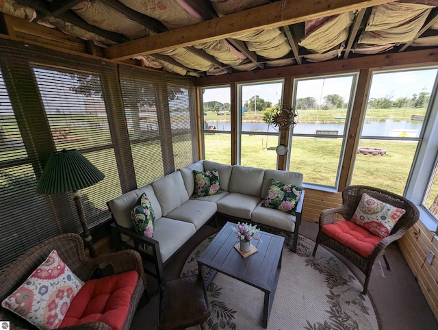 sunroom / solarium featuring a healthy amount of sunlight and a water view