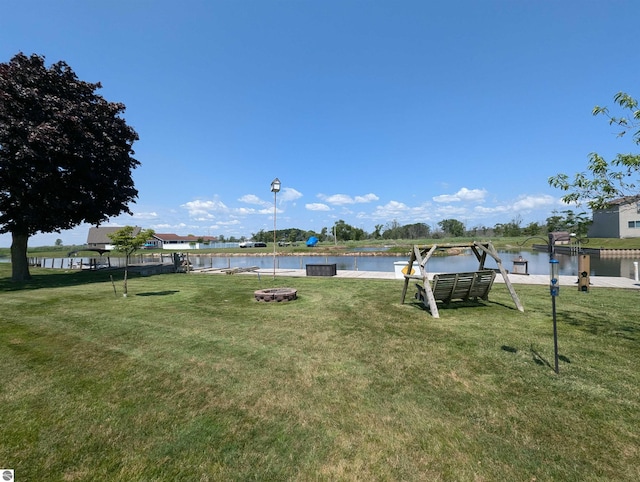 view of yard featuring a water view and a fire pit