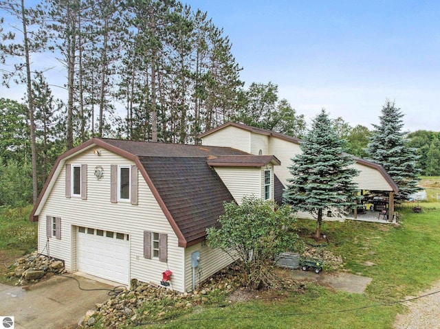 view of property exterior featuring a garage and a yard