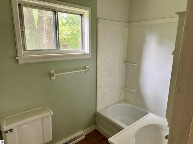 full bathroom with toilet, parquet flooring, sink, and bathtub / shower combination