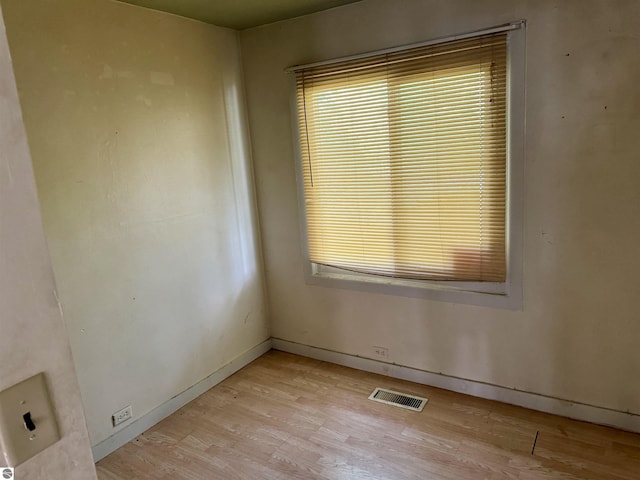 unfurnished room with light wood-type flooring