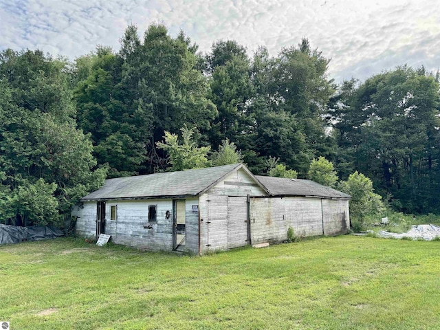 view of outbuilding with a yard