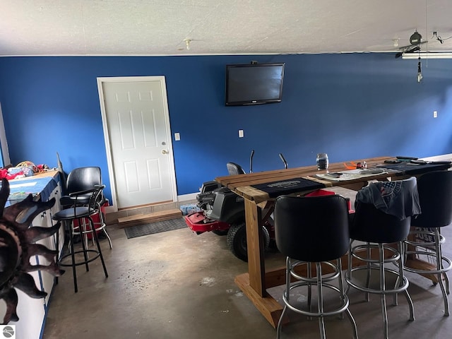 interior space featuring concrete flooring and a textured ceiling