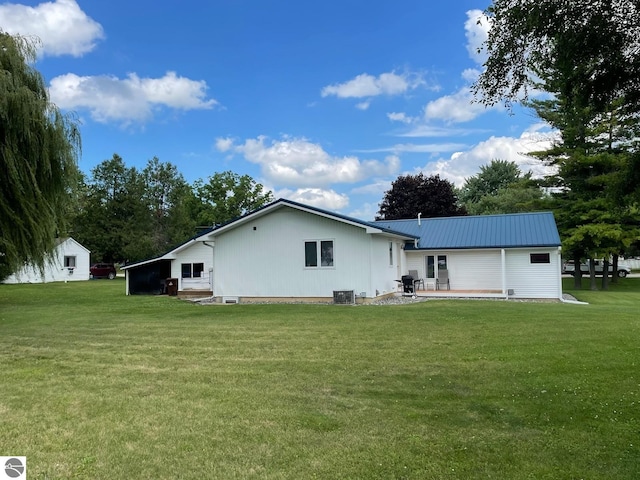 back of property with a yard, a patio, and central AC unit