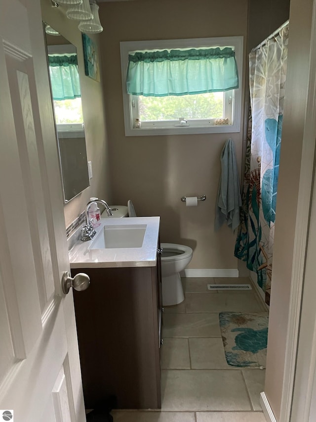 bathroom with vanity, tile patterned floors, and toilet