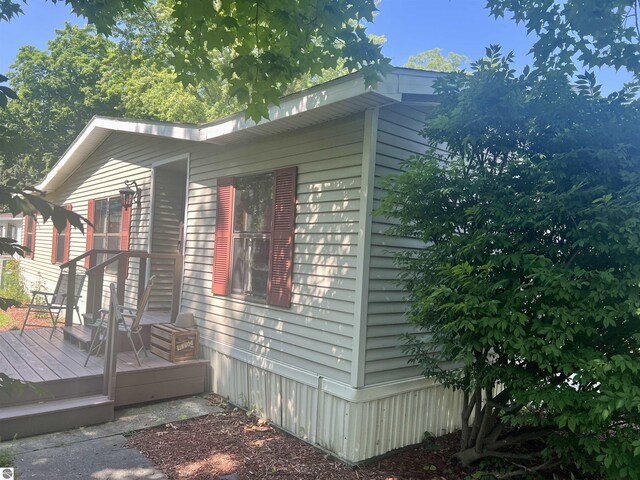 view of side of home with a deck