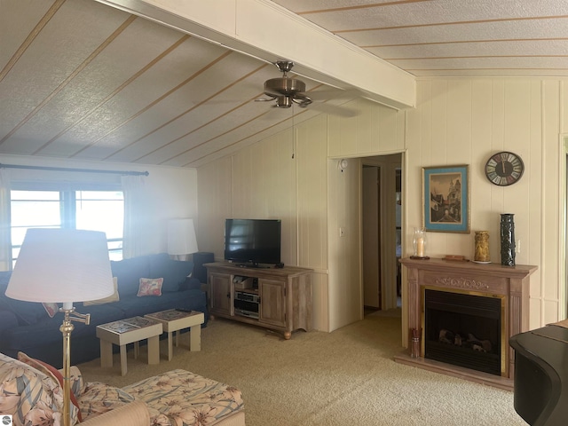 living room featuring carpet, ceiling fan, and vaulted ceiling with beams