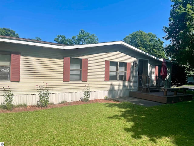 view of property exterior with a wooden deck and a lawn