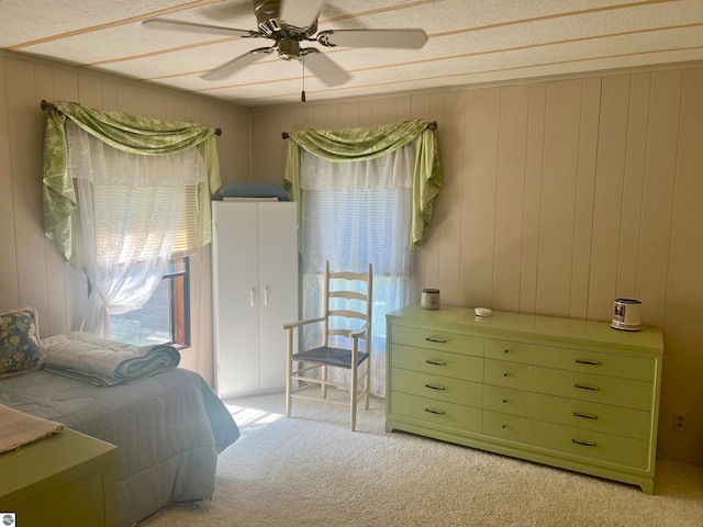 carpeted bedroom with a textured ceiling and ceiling fan