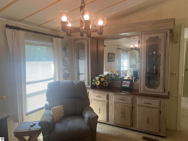 sitting room with light carpet, lofted ceiling, and a notable chandelier